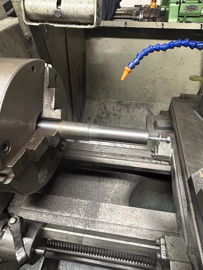 Modified mandrel with taper removed and casting held with studding andnut 